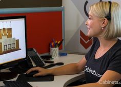 a woman sitting in front of a computer monitor