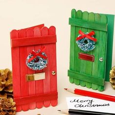 two wooden doors decorated with christmas wreaths and pine cones are next to a note that says merry christmas