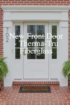 a white door with the words new front door therma - tru fireglass