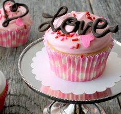 cupcakes with pink frosting and hearts on top