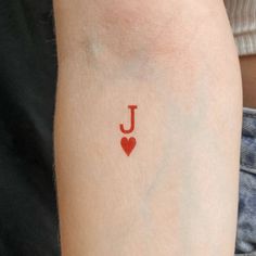 a person with a tattoo on their arm that has the letter j painted on it