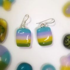 three pairs of earrings with different colors on them