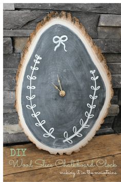 a clock that is on top of a piece of wood with writing on the side