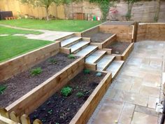 an outdoor garden with steps leading up to the grass