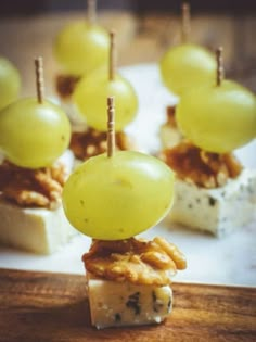 grapes and cheese are stacked on top of crackers