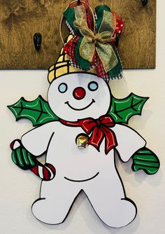 a snowman ornament hanging on a wall