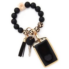 the black and gold bracelet has a key chain attached to it with a leopard print charm