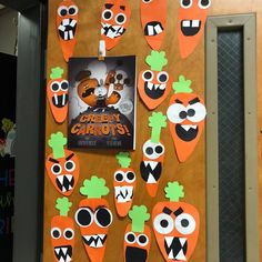 a bulletin board with cut out carrots on it, and an ad for the children's book creepy carrots