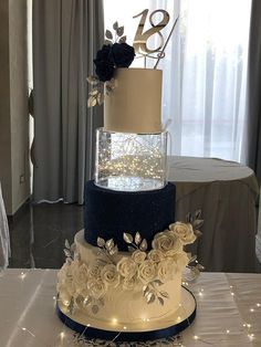 a three tiered wedding cake with flowers on top