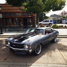 an old muscle car parked on the street