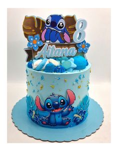 a blue and white birthday cake with an image of stitcher from the movie lilpui