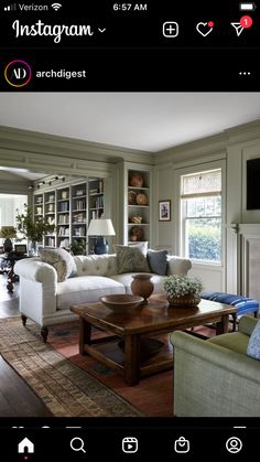 a living room filled with furniture and a fire place in front of a book shelf