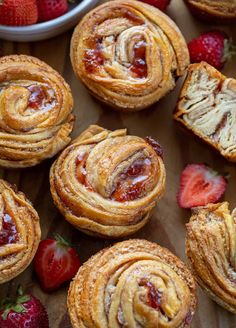 several pastries on a wooden table with strawberries