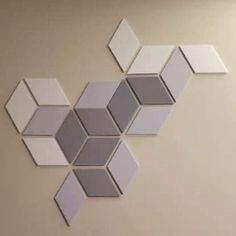 several mirrors are arranged on the wall in an artistic manner, including hexagonal shapes