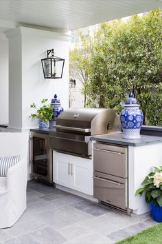 an outdoor kitchen with blue and white vases