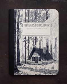 a black and white photo of a log cabin in the woods with text that reads deco composition book