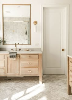 a bathroom with two sinks and a large mirror