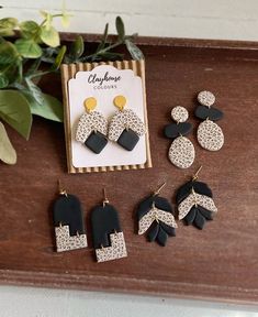 the black and white earrings are on display next to an earring with leopard print