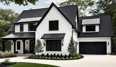 a large white house with black roof and two car garages in front of it