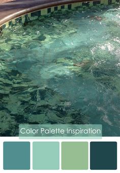 an outdoor swimming pool with blue and green colors in the water next to a wooden deck