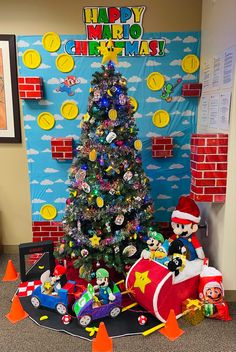 a decorated christmas tree in an office cubicle with toys and decorations on the floor