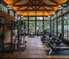 an indoor gym with lots of exercise equipment