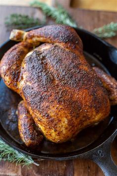 a close up of a chicken in a pan on a table