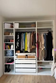 a white closet filled with lots of clothes