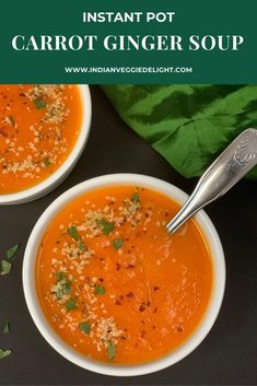 two bowls of instant pot carrot ginger soup on a black table with green napkin and spoon