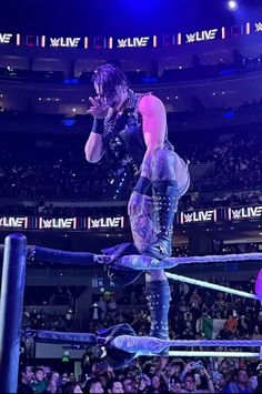 a man standing on top of a wrestling ring