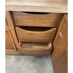 a close up of a drawer in a wooden cabinet with drawers and doors on both sides