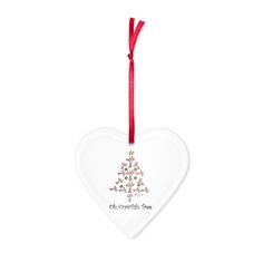 a white heart shaped ornament with a red ribbon hanging from it's side