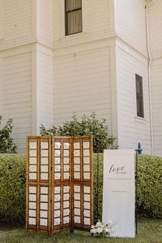 an outdoor ceremony set up in front of a large white building with two wooden doors