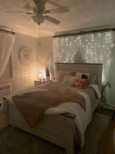 a bed room with a neatly made bed and a ceiling fan