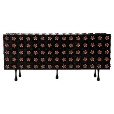 a black and brown flowered headboard with long legs