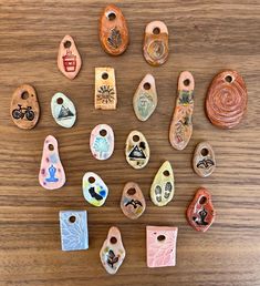 many different shaped and colored ceramic items on a wooden surface with holes in the middle