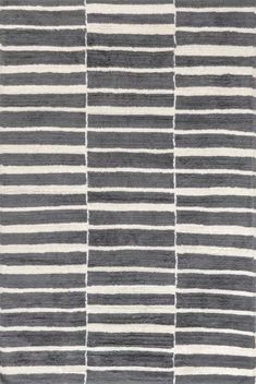 a gray and white rug with stripes on it