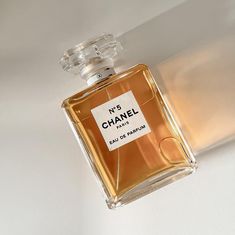 a bottle of chanel no 5 eau de parfum on a white surface