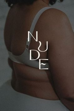 a woman with her back turned to the camera, wearing a white bra and panties