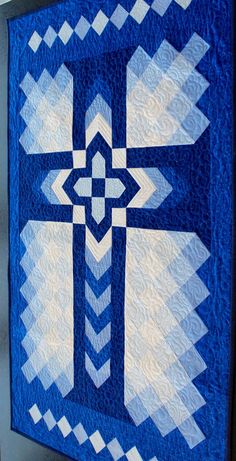 a blue and white quilt with an intricate design