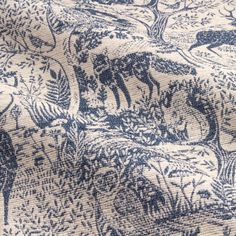 the fabric is blue and white with animals on it's side, as well as trees