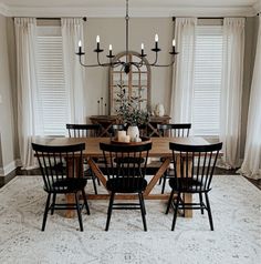 a dining room table with chairs and a chandelier