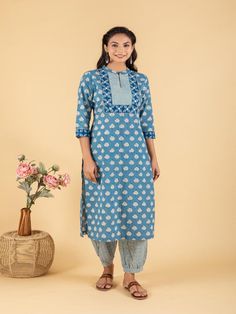 Blue dabu flower printed straight kurta, has a mandarin collar, mirror and katha embroidered yoke, three-quarter sleeves and stripes Print afgani Pants has Elasticated Waistband Fabric: 100% Cotton Color: Blue Note: Available in other colors Wash Care Instruction - Dry Clean Only The product will be shipped within 15-20 days of order placed Size Chart: Kurta Size XS S M L XL XXL XXXL Bust 36 38 40 42 44 46 Waist 32 34 36 38 40 42 Hip 38 40 42 44 46 48 Shoulder 14 14.5 15 15.5 16 16.5 Armhole 18 Indigo Unstitched Straight Kurta, Unstitched Indigo Straight Kurta, Indigo Cotton Kurta For Festive Occasions, Blue Kurta With Printed Motifs For Spring, Casual Blue Kurta For Diwali, Casual Cotton Traditional Wear For Eid, Spring Straight Kurta Salwar Kameez With Printed Border, Indigo Cotton Kurta For Festivals, Spring Salwar Kameez With Printed Border And Straight Kurta