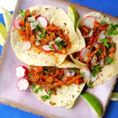 three tortillas with shredded carrots, radishes and cilantro