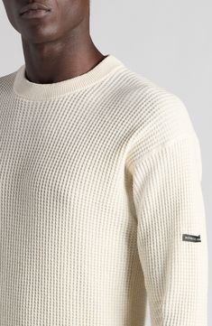 An embroidered label marks one sleeve of this hemp-and-cotton waffle-knit sweater that moves the crewneck's reinforced 'V' to the back for signature branding. 26" length (size large) Crewneck Long sleeves Ribbed cuffs and hem 55% hemp, 45% cotton Dry clean Made in Italy Designer Clothing White Crew Neck Sweater With Ribbed Collar, Off White Textured Knit Long Sleeve Sweater, Off White Long Sleeve Textured Knit Sweater, Cream Ribbed Crew Neck Sweater, Cream Cotton Sweater With Ribbed Collar, Off White Textured Knit Crew Neck Sweater, Casual White Merino Wool Tops, Cream Cotton Sweater With Ribbed Cuffs, Cream Crew Sweater With Ribbed Cuffs