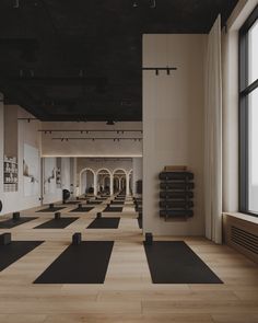 an empty gym with yoga mats on the floor