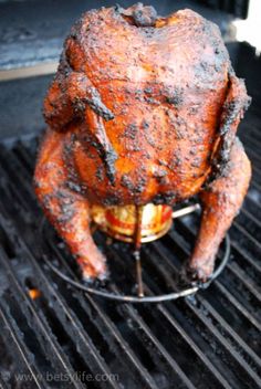 a chicken sitting on top of a grill with the words, awesome beer can chicken