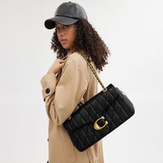 A modern take on an archival 1970s Coach design our structured Tabby shoulder bag is crafted of luxe quilted nappa leather. Finished with our Signature hardware for an iconic touch the 33 is a spacious style with a secure inside zip pocket a convenient outside pocket and plenty of room for essentials including a mini tablet. Keep the leather-and-chain strap long to wear it crossbody or double it for a shorter dressier look. | Coach Tabby Shoulder Bag 33 With Quilting - Women's - Brass/black Coach Tabby Outfit, Never Full Bag, Coach Tabby Shoulder Bag, Tabby Shoulder Bag, Coach Tabby, Mini Tablet, Bags Coach, Signature Hardware, Sport Bag