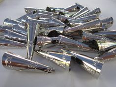 many shiny metal objects on a white surface