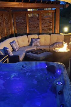 a hot tub sitting next to a fire pit